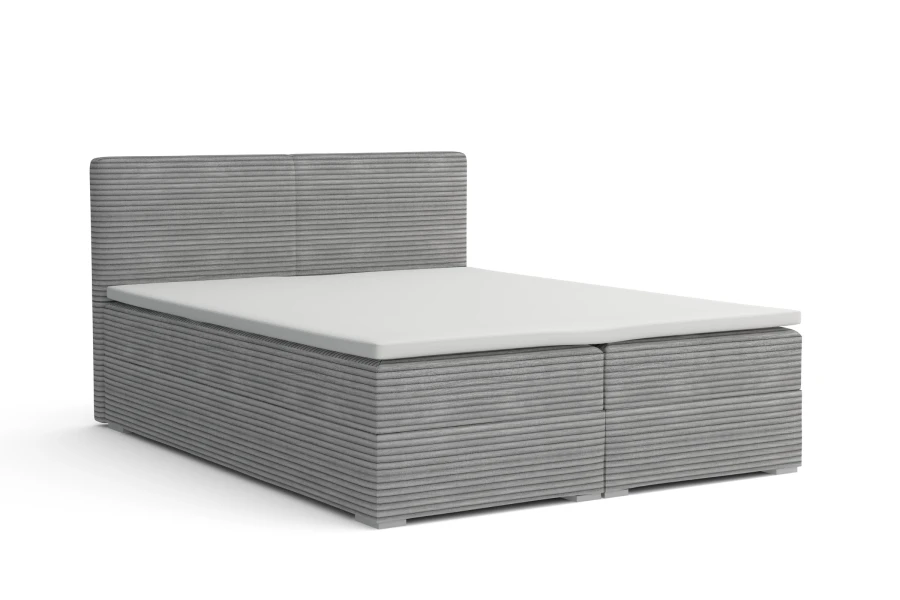 Hellgraues Boxspringbett in Cord-Optik auf weißem Hintergrund