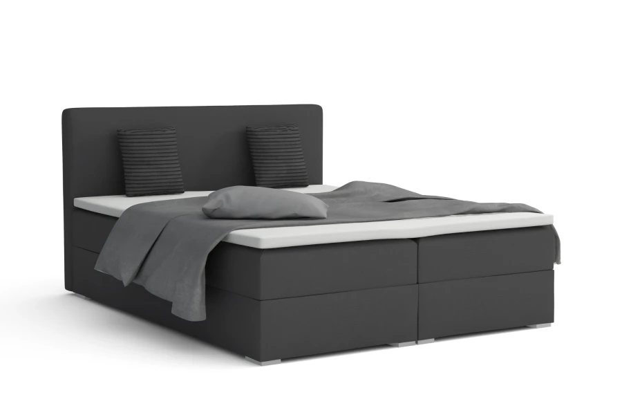 Dunkelgraues Boxspringbett Bello mit modernem Kopfteil und Kissen.