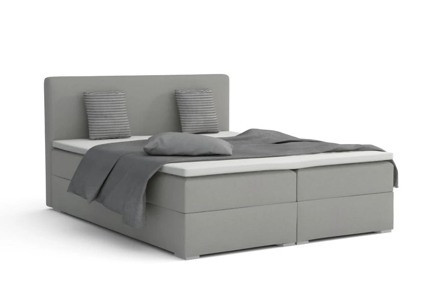 Graues Boxspringbett Bello mit Kissen und Decke in eleganter, schlichter Optik für das Schlafzimmer.