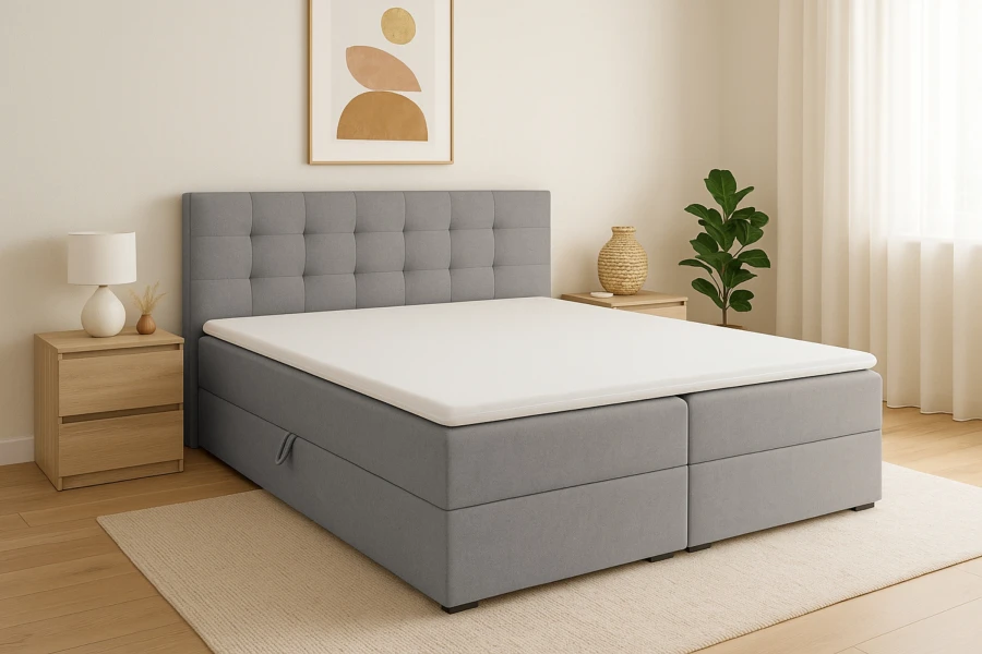 Modernes graues Boxspringbett Florida mit gestepptem Kopfteil in hellem Schlafzimmer-Ambiente.