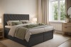 Modernes Boxspringbett in Anthrazit mit kristallbesetztem Kopfteil in einem hellen Schlafzimmer.