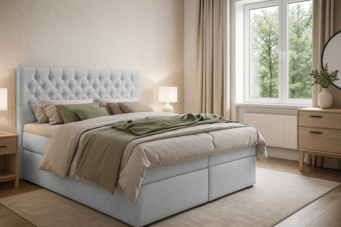 Modernes Schlafzimmer mit grauem Boxspringbett und hellen Möbeln