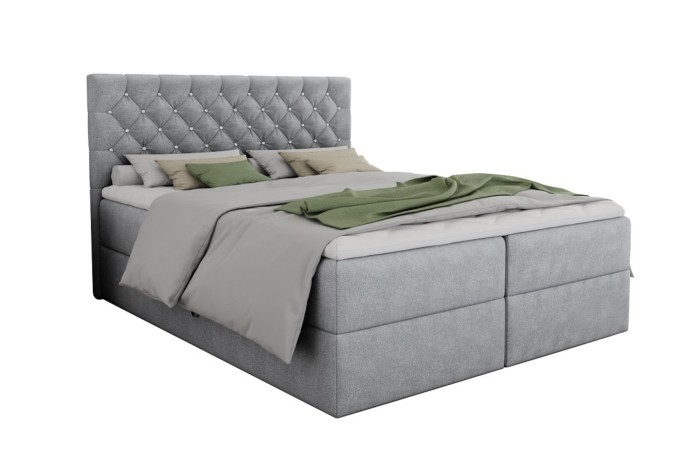 Freigestellte Ansicht des hellgrauen Boxspringbetts Arami mit gestepptem Kopfteil.