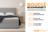 Graues Bouclé Boxspringbett mit Details zu Bettkasten, Farbauswahl und Kaltschaum-Topper.