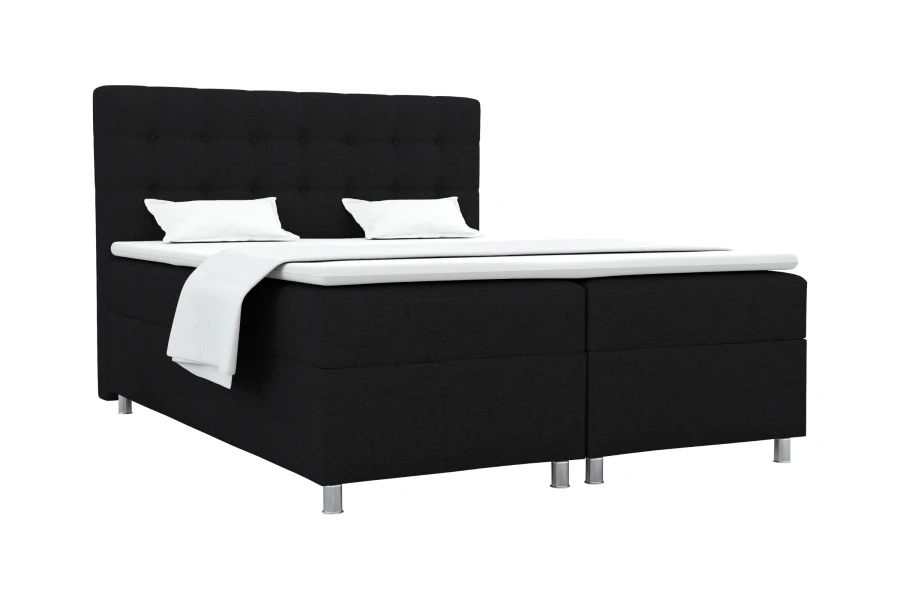 Modernes Boxspringbett in Schwarz mit weißem Topper und Kissen auf weißem Hintergrund.