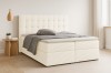 Helles beiges Boxspringbett Carly mit Cord-Stoff und gestepptem Kopfteil in modernem Raum.