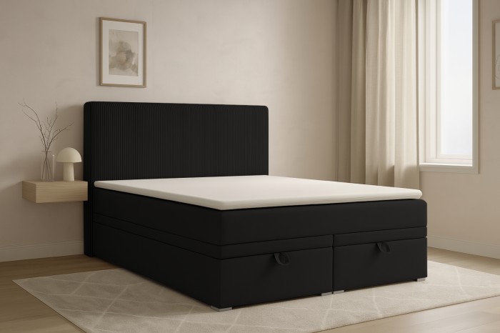 Schwarzes Boxspringbett Daga mit gepolstertem Kopfteil und Bettkasten im modernen Schlafzimmer.