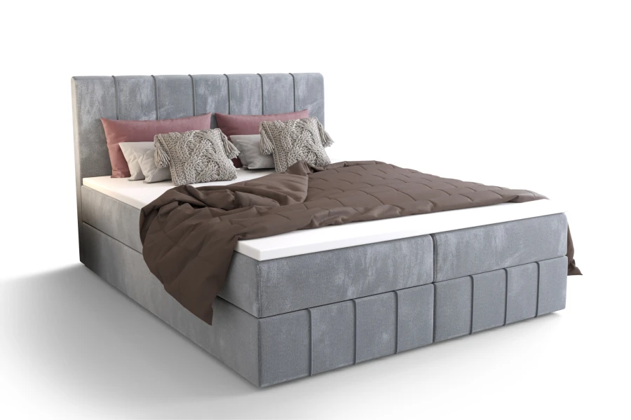 Hellgraues Boxspringbett mit braunem Plaid auf weißem Hintergrund freigestellt.