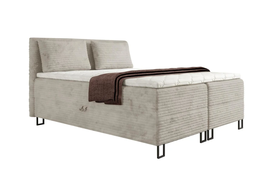 Stilvolles Boxspringbett in Beige mit Cord-Bezug, Kopfteil und Kissen-Set.