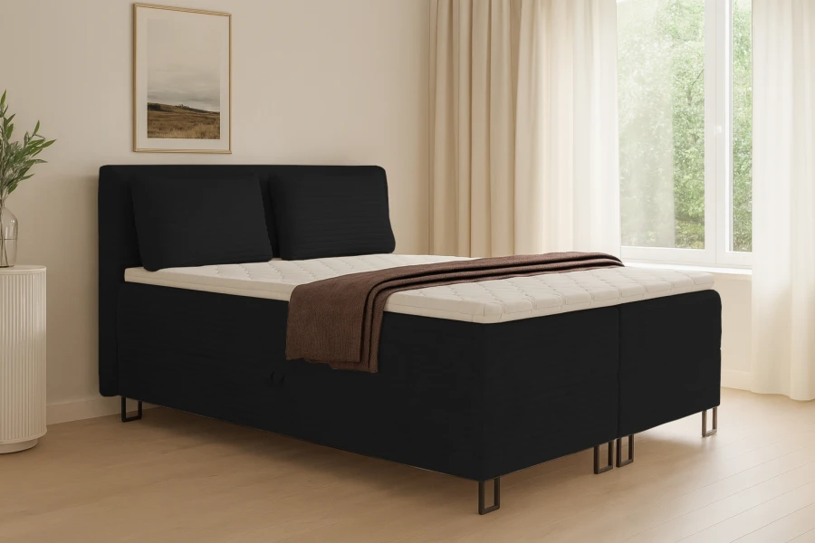 Elegantes schwarzes Cord-Boxspringbett in einem hellen, modern eingerichteten Schlafzimmer.