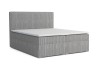 Hellgraues Boxspringbett mit strukturiertem Cord-Bezug auf weißem Hintergrund freigestellt.