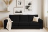 Schwarzes Cord-Sofa im modern eingerichteten Wohnzimmer mit Wandbildern und Dekoration.