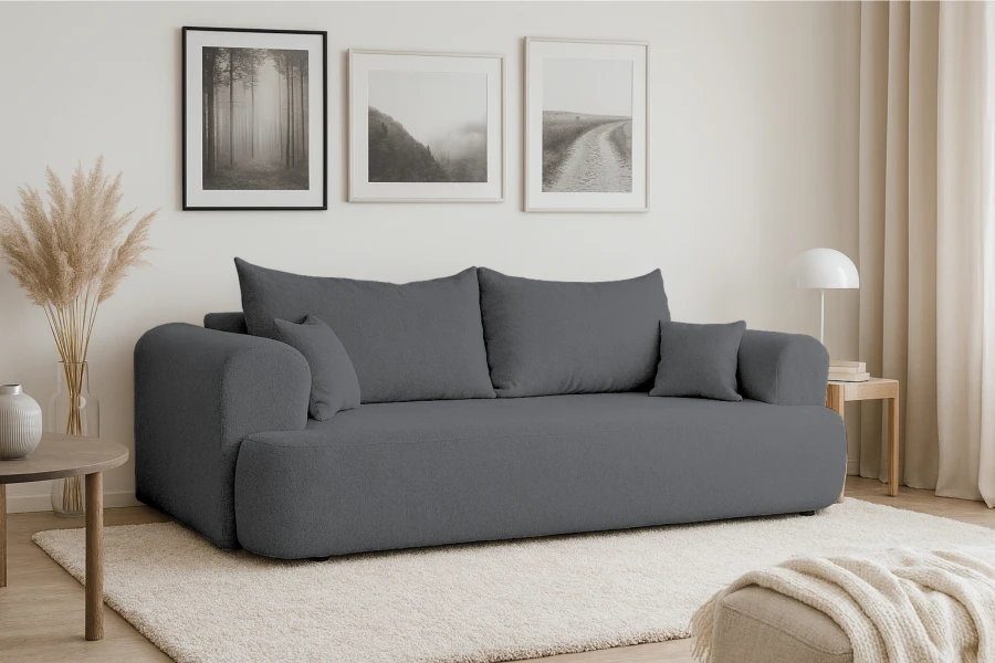 Graues Polstersofa in minimalistischem Wohnzimmer mit Natur-Wandbildern und Deko.