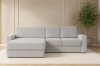 Stilvolles Ecksofa TOCO XL in hellem Bouclé-Stoff in einem modern eingerichteten Wohnzimmer.