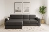 Modernes Ecksofa in Anthrazit mit Cordbezug im hellen Wohnzimmer.
