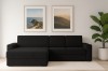 Schwarzes L-Sofa in stilvollem Wohnzimmer mit Wandbildern und Pflanzen