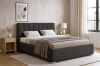 Modern eingerichtetes Schlafzimmer mit anthrazitfarbenem Polsterbett