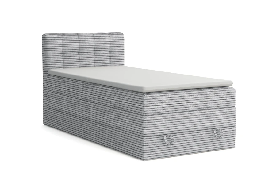 Graues Boxspringbett JUNG II mit Cord-Bezug und gepolstertem Kopfteil vor weißem Hintergrund.