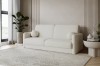 Modernes beiges Sofa aus Bouclé-Stoff in einem hellen, minimalistischen Wohnzimmer.