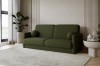 Grünes Bouclé-Sofa mit runden Kissen in einem hellen Wohnzimmer mit modernen Akzenten.