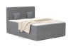 Grijs boxspringbed in moderne corduroy-look met bijpassende kussens en deken.