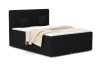 Zwart boxspringbed in corduroy-look met beige deken op een witte achtergrond.