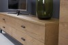 Detailaufnahme TV-Lowboard Liam: Eichenoptik mit schwarzen Griffen, dekoriert mit Vase und Fernseher.