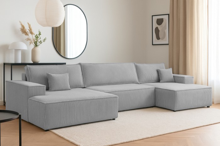 Gemütliches graues Ecksofa aus Cord in einem modern eingerichteten Wohnzimmer.