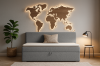Elegant grey sofa bed in a modern living environment with world map wall decoration.