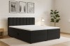 Schwarzes Boxspringbett mit gestepptem Kopfteil in einem modernen Schlafzimmer.
