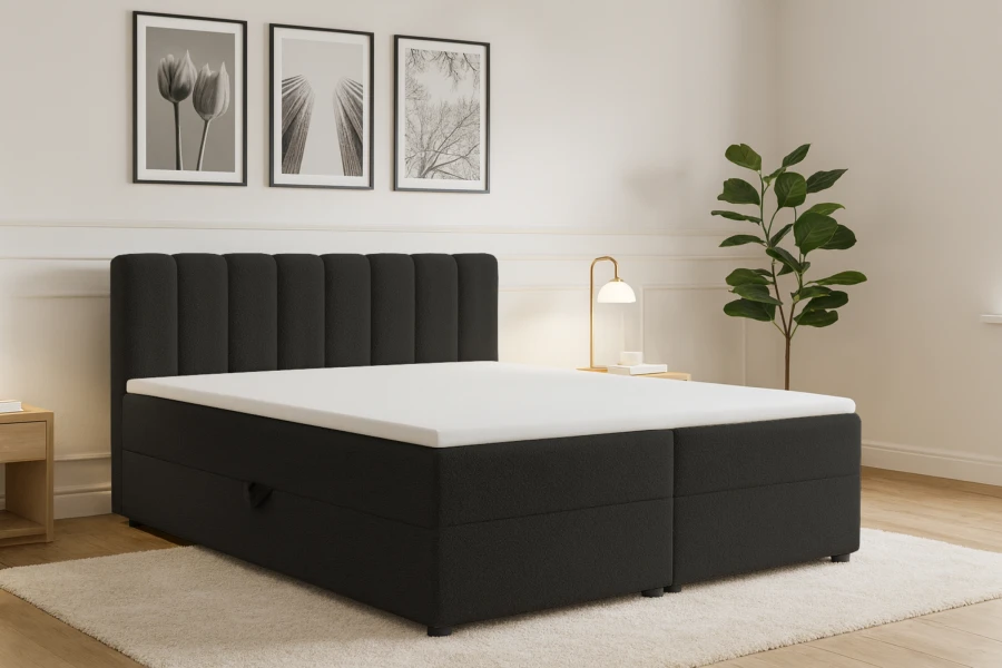 Schwarzes Boxspringbett mit gestepptem Kopfteil in einem modernen Schlafzimmer.
