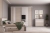 Moderne slaapkamerset in beige met schuifdeurkast, bed met opbergruimte en bijpassende commode.