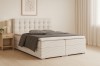Gemütliches Schlafzimmer mit beigem Cord-Boxspringbett, Holz-Nachttisch und minimalistischer Wandkunst.