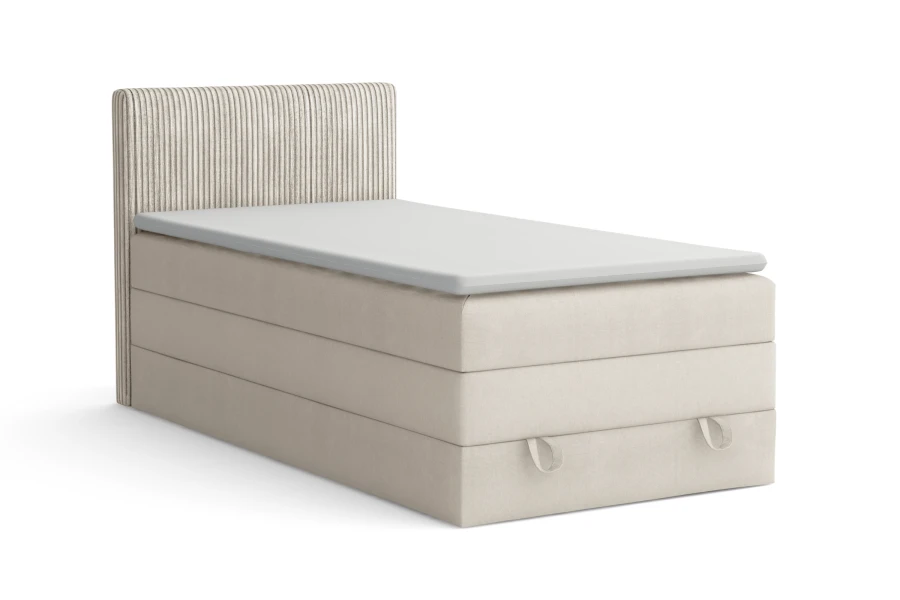 Beiges Boxspringbett mit geriffeltem Kopfteil und integriertem Bettkasten auf weißem Hintergrund.