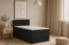 Stilvolles schwarzes Boxspringbett mit Stauraum in einem hell eingerichteten, modernen Schlafzimmer.