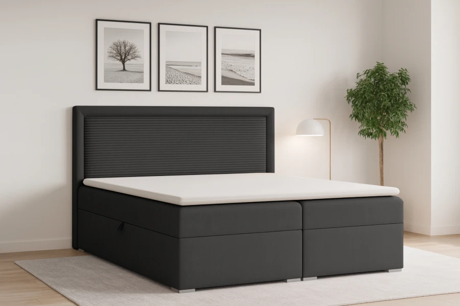 Anthrazitfarbenes Boxspringbett mit geriffeltem Kopfteil und weißem Topper im modernen Schlafzimmer.