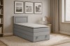 Graues Boxspringbett in modern eingerichtetem Schlafzimmer.