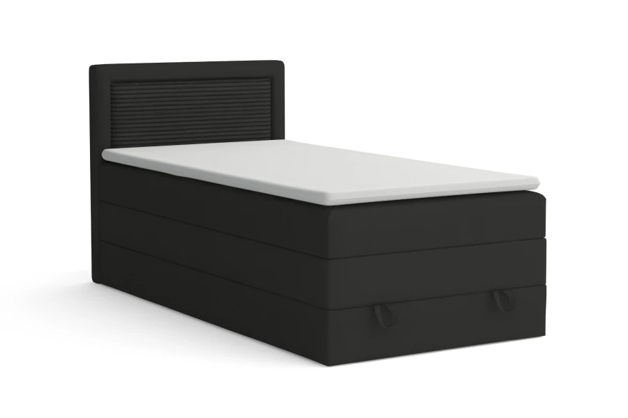 Schwarzes Boxspringbett mit strukturiertem Kopfteil vor weißem Hintergrund.