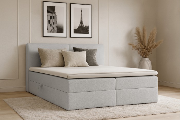 Lina Boxspringbett in Hellgrau mit passenden Kissen in modernem Schlafzimmer-Ambiente.