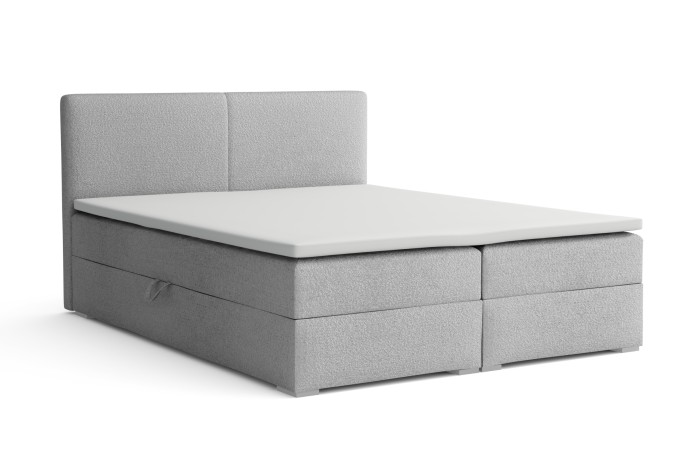 Modernes hellgraues Boxspringbett mit gepolstertem Kopfteil und weißer Matratze.