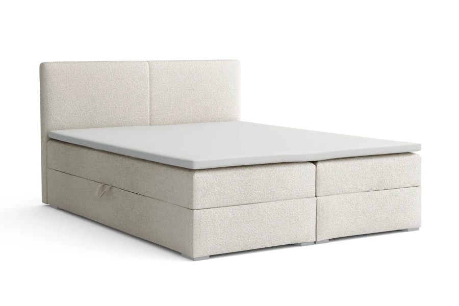 Beiges Boxspringbett mit Bettkasten und hohem Kopfteil, modern gestaltet.