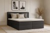 Anthrazitfarbenes Boxspringbett im Schlafzimmer-Ambiente mit Wandbildern.