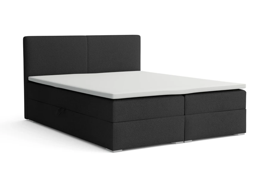 Elegantes schwarzes Boxspringbett mit weißer Matratzenauflage.