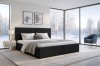Modernes schwarzes Polsterbett im hellen Schlafzimmer mit winterlichem Ausblick durch große Fenster.