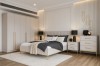 Luxuriös eingerichtetes Schlafzimmer mit beigem Polsterbett, Schrank und Kommode.