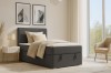 Anthrazitfarbenes Boxspringbett im modern eingerichteten Schlafzimmer mit Kopfteil.