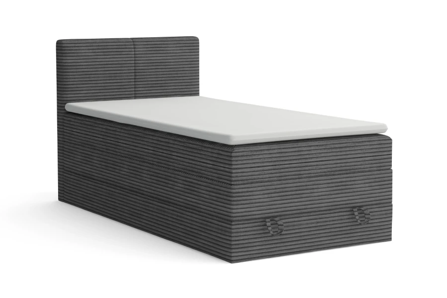 Anthrazitfarbenes Boxspringbett mit Cord-Stoff Poso und weißem Topper vor weißem Hintergrund.