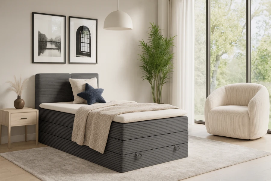 Stylish bedroom with grey corduroy single bed, beige armchair and modern decoration.