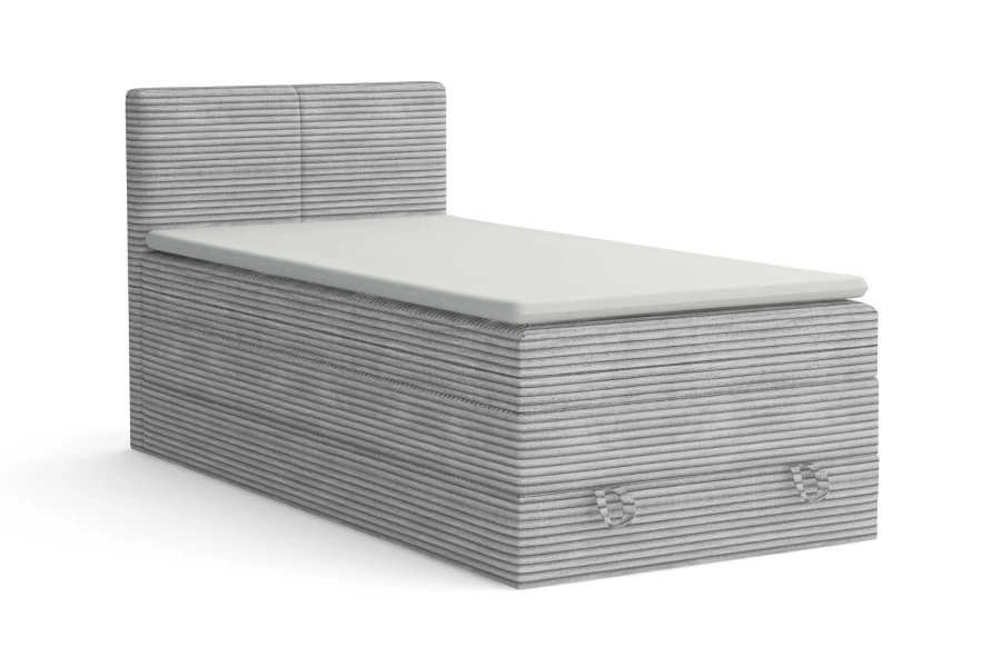 Hellgraues Boxspring-Einzelbett mit Cord-Bezug und weißem Topper auf weißem Grund
