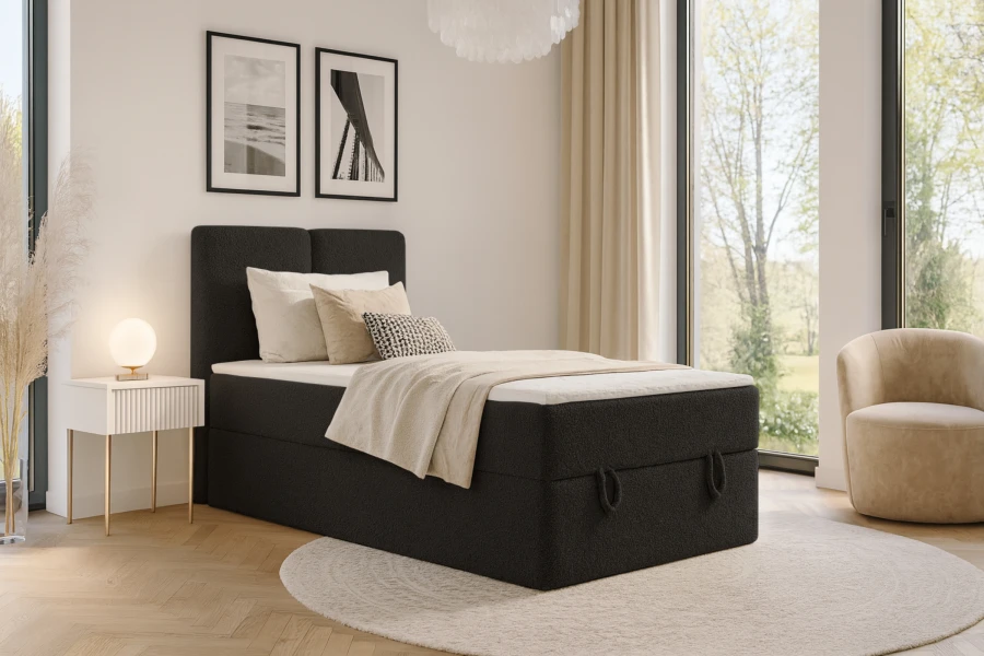 Schwarzes Einzelbett im modern eingerichteten Schlafzimmer mit Deko.